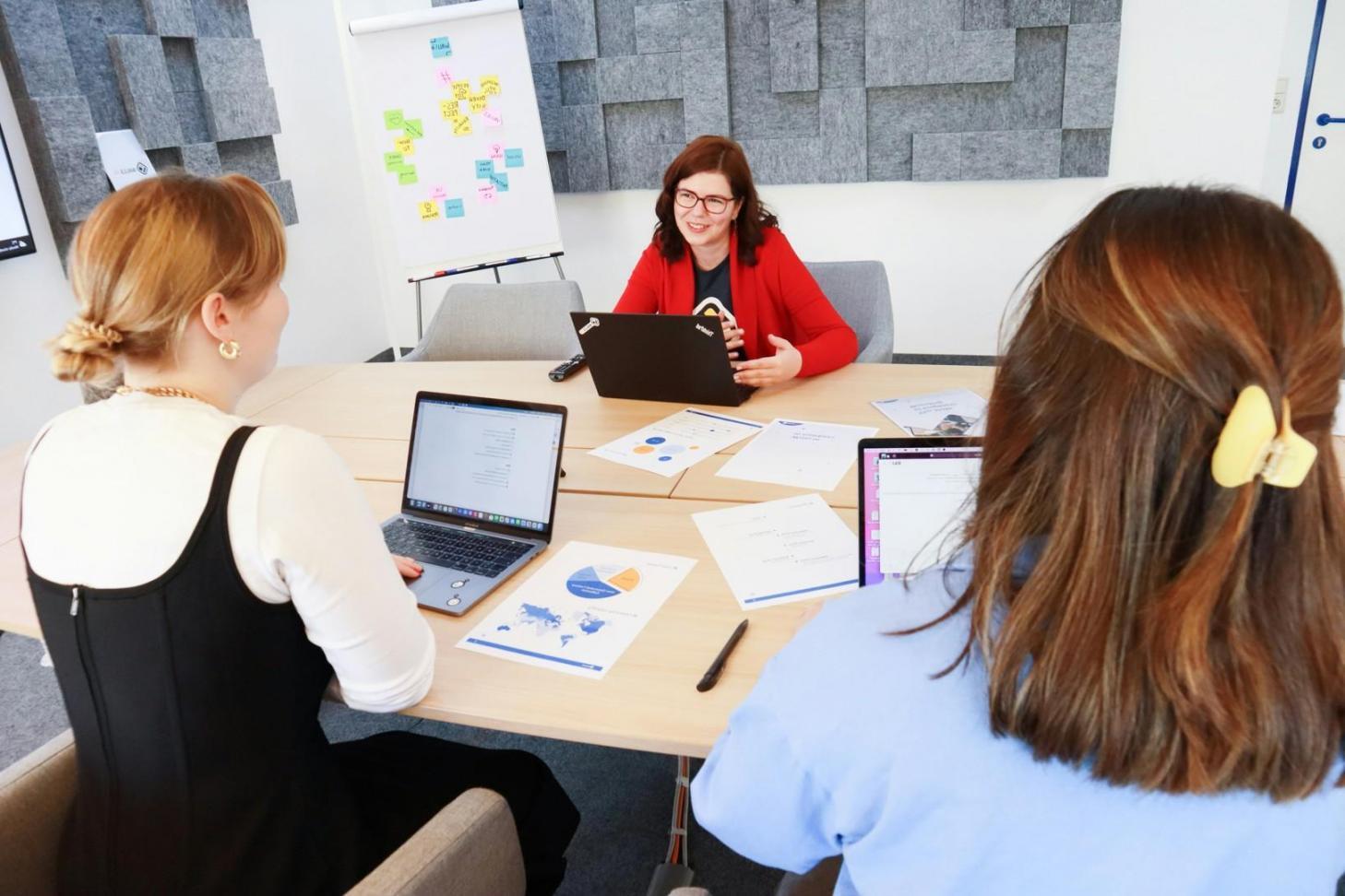 Financial planning session with collaborative team reviewing budget documents